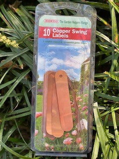 Copper swing labels in packaging against grass